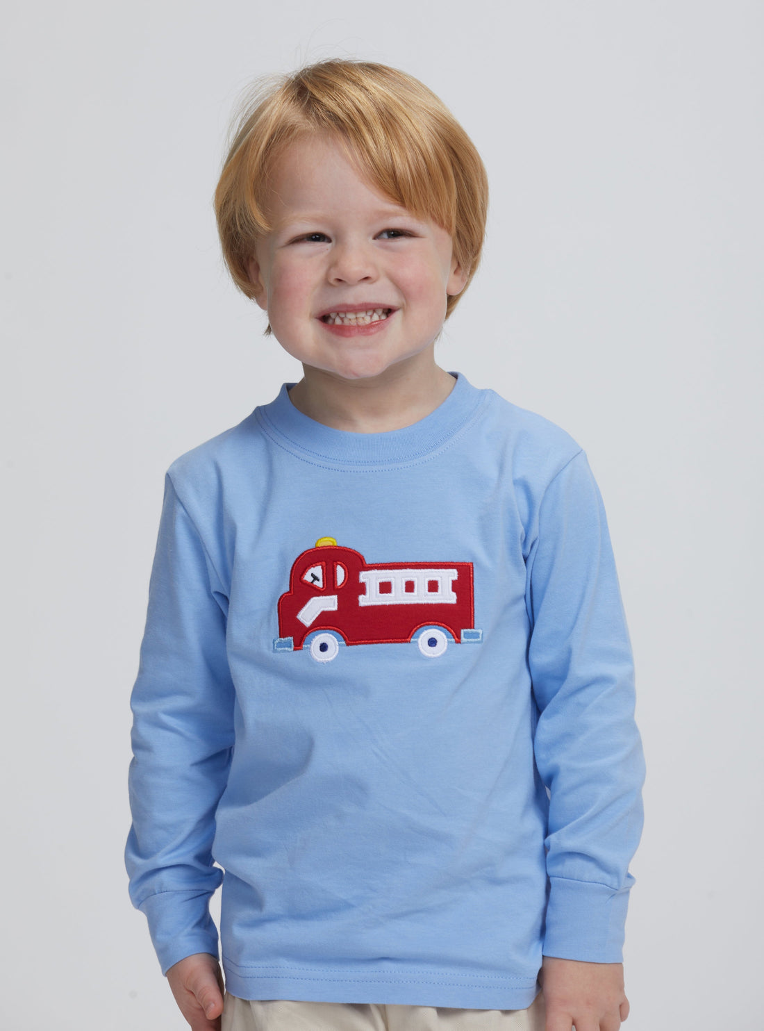 Little English traditional clothing, light blue knit long sleeve shirt with fire truck applique on chest for little boy with basic short in pebble twill