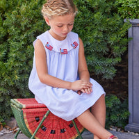 Little English traditional children's clothing.  Girl's light blue and white stripe seersucker dress with flag applique for summer.  Girl's 4th of July outfit
