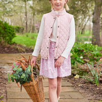 Little English traditional clothing, smocked skirt in pink and orange oakleigh floral pattern, smocked waistband with bow in center for little girl