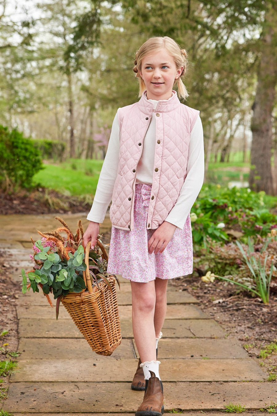 Little English traditional clothing, smocked skirt in pink and orange oakleigh floral pattern, smocked waistband with bow in center for little girl