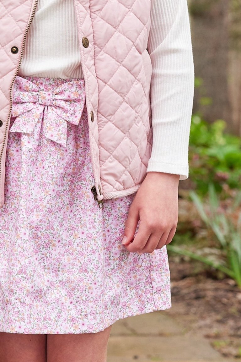 Little English traditional clothing, smocked skirt in pink and orange oakleigh floral pattern, smocked waistband with bow in center for little girl