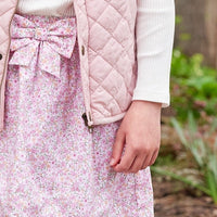 Little English traditional clothing, smocked skirt in pink and orange oakleigh floral pattern, smocked waistband with bow in center for little girl