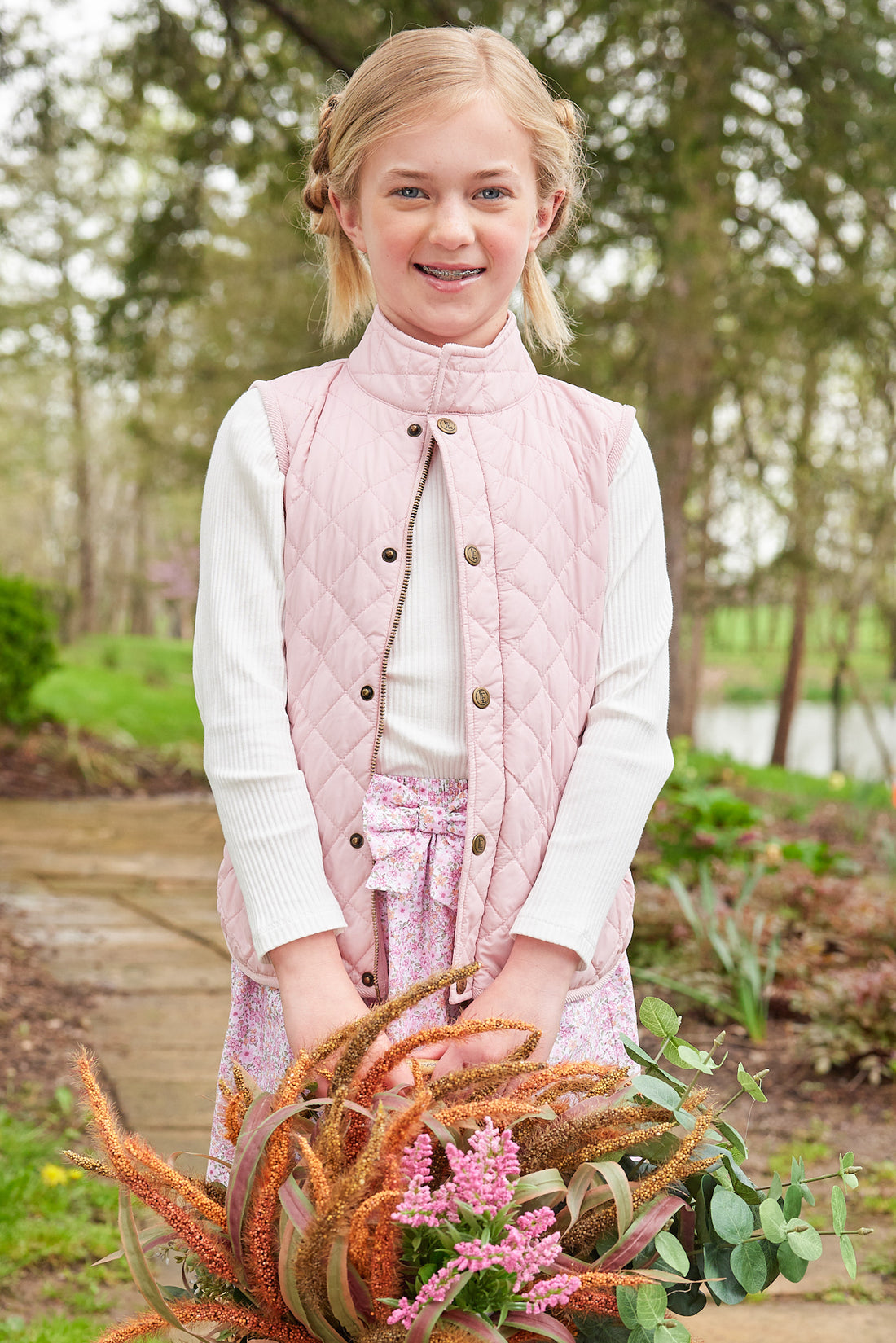 Little English traditional clothing, smocked skirt in pink and orange oakleigh floral pattern, smocked waistband with bow in center for little girl