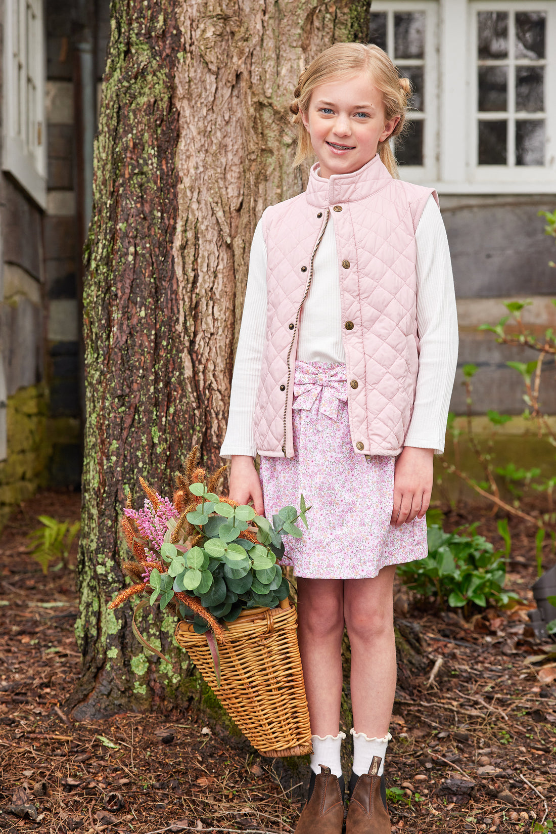 Little English traditional clothing, smocked skirt in pink and orange oakleigh floral pattern, smocked waistband with bow in center for little girl