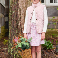 Little English traditional clothing, smocked skirt in pink and orange oakleigh floral pattern, smocked waistband with bow in center for little girl