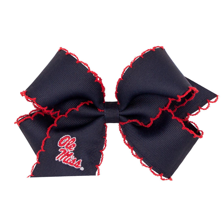 Little English traditional children's clothing.  Navy grosgrain hair bow trimmed in red with red and white Ole Miss logo embroidery.  Game day hair bow for girls for Fall