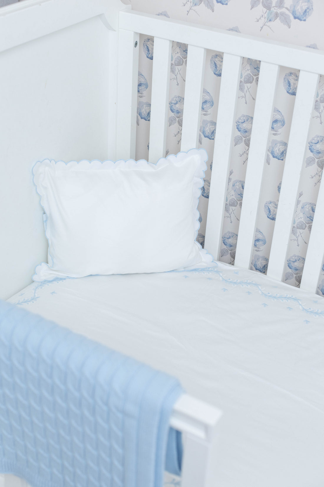 Little English classic nursery goods for baby, white crib sheet with simple light blue embroidery along the edges for baby