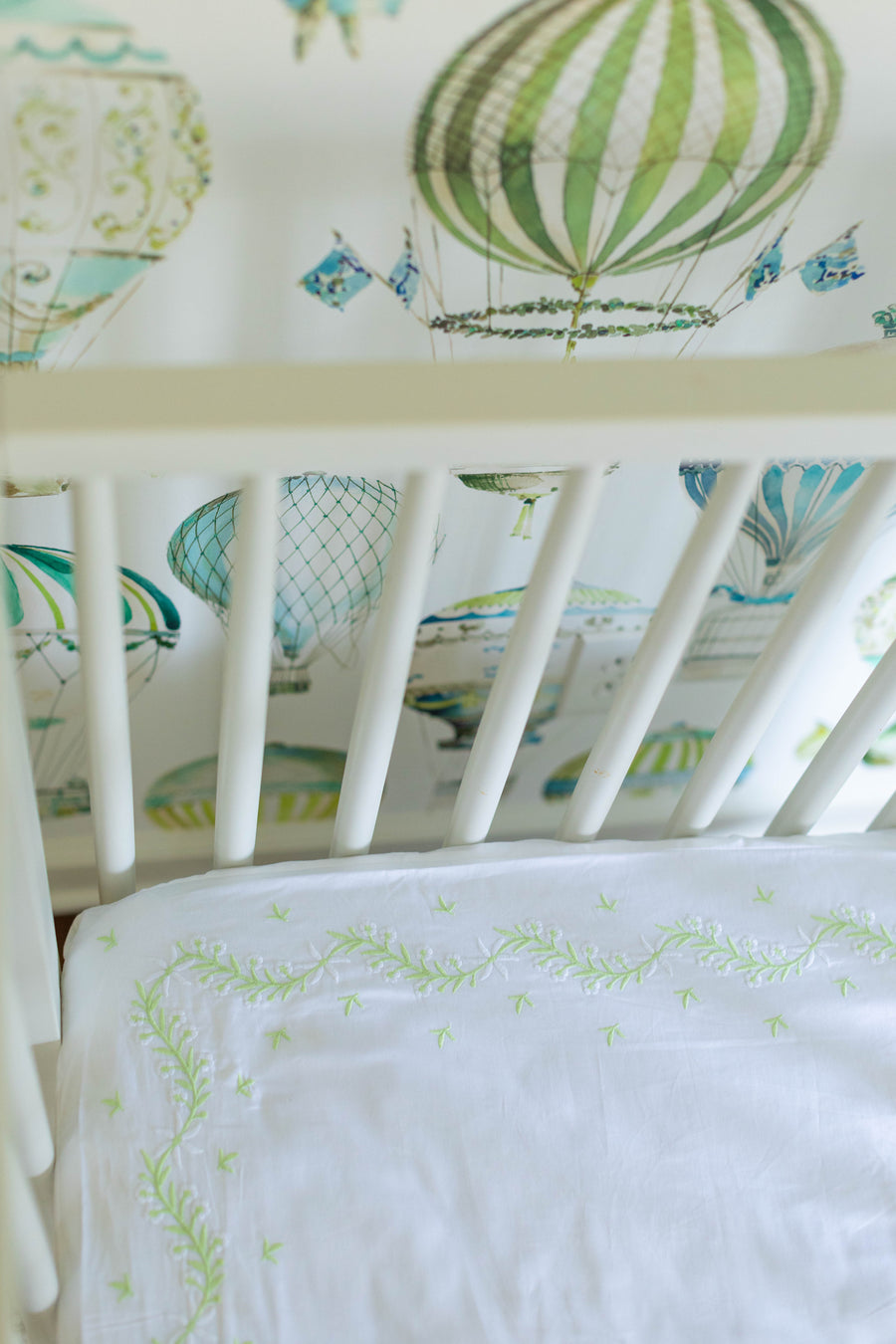 Little English classic nursery goods for baby, white crib sheet with simple light green embroidery along the edges for baby