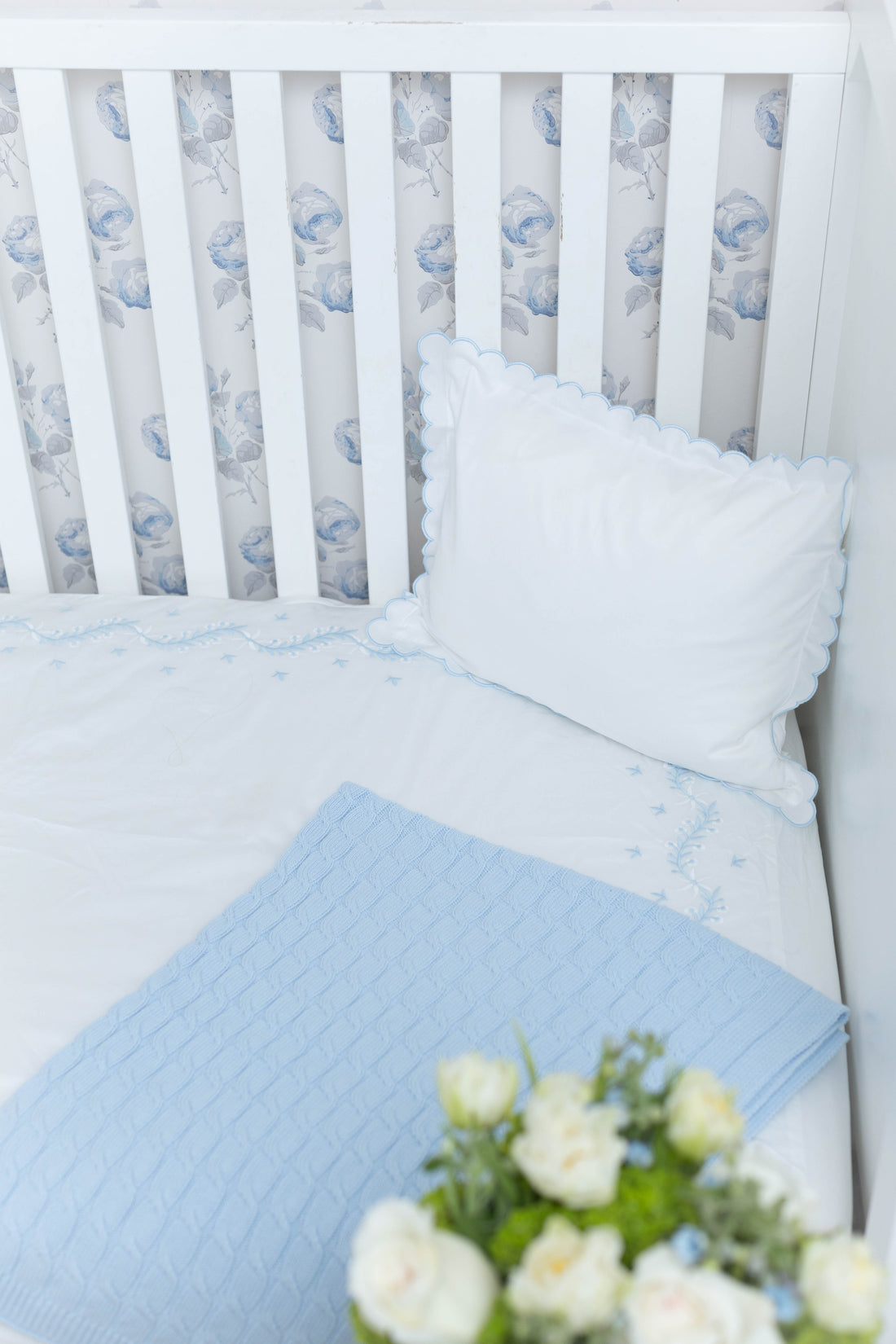 Little English classic nursery goods for baby, white crib sheet with simple light blue embroidery along the edges for baby