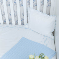 Little English classic nursery goods for baby, white crib sheet with simple light blue embroidery along the edges for baby