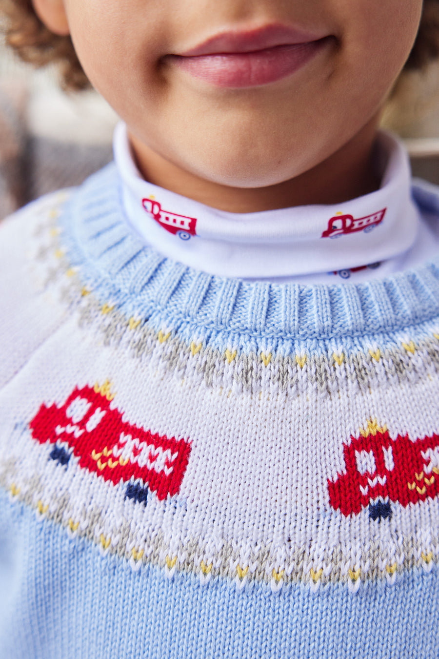 Little English traditional children's clothing. Boy light blue fair isle sweater with fire trucks for Fall