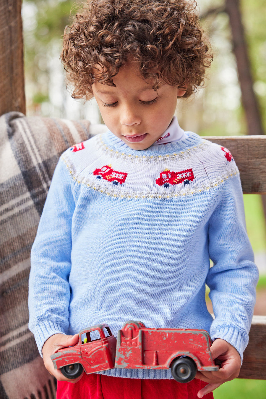 Little English traditional children's clothing. Boy light blue fair isle sweater with fire trucks for Fall