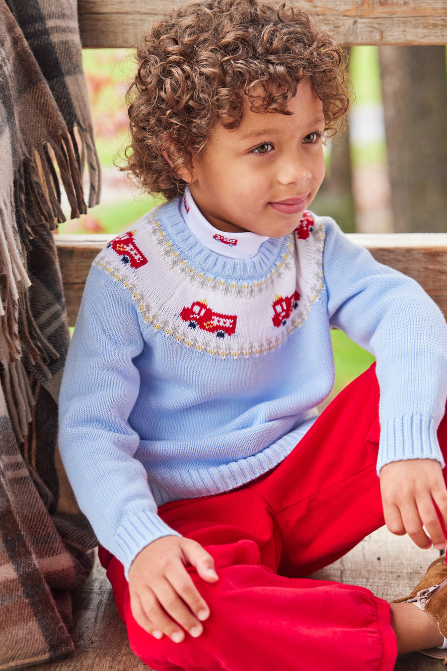 Little English traditional children's clothing. Boy light blue fair isle sweater with fire trucks for Fall