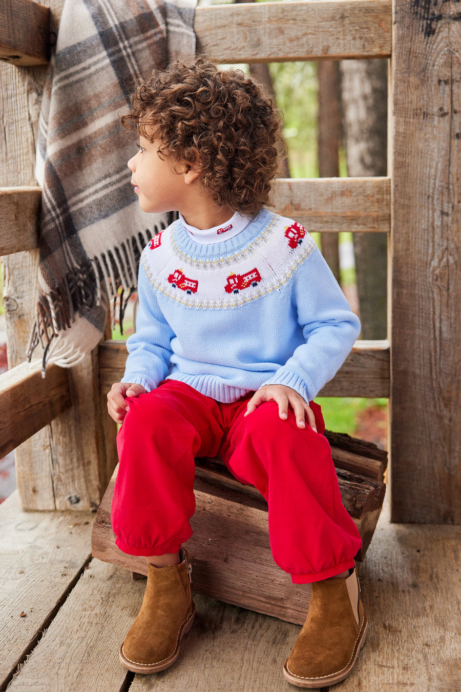 Little English traditional children's clothing. Boy light blue fair isle sweater with fire trucks for Fall