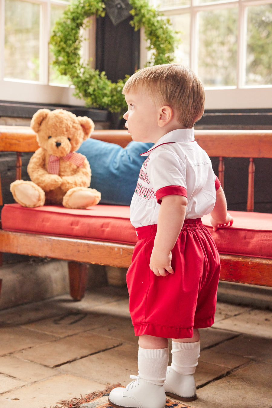 Little English traditional children's clothing, Graham Short Set with red bottoms and collared white top, smocked detailing on chest and buttons around hips, for little boy