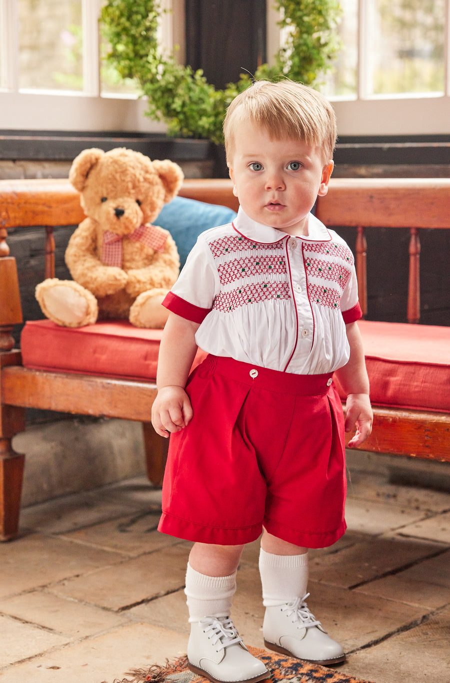 Little English traditional children's clothing, Graham Short Set with red bottoms and collared white top, smocked detailing on chest and buttons around hips, for little boy