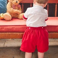 Little English traditional children's clothing, Graham Short Set with red bottoms and collared white top, smocked detailing on chest and buttons around hips, for little boy