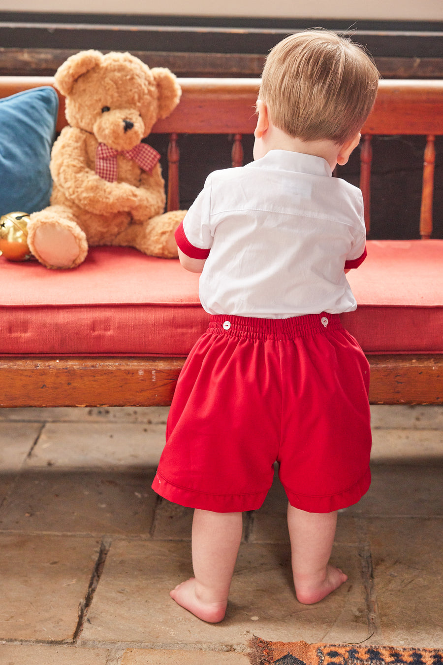 Little English traditional children's clothing, Graham Short Set with red bottoms and collared white top, smocked detailing on chest and buttons around hips, for little boy