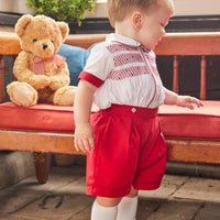 Little English traditional children's clothing, Graham Short Set with red bottoms and collared white top, smocked detailing on chest and buttons around hips, for little boy