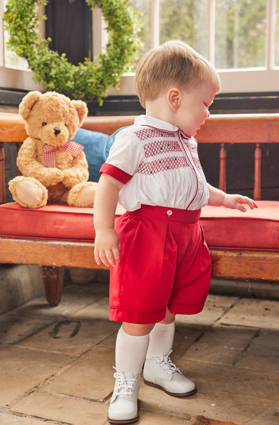 Little English traditional children's clothing, Graham Short Set with red bottoms and collared white top, smocked detailing on chest and buttons around hips, for little boy