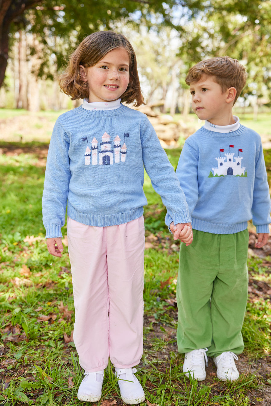 Little English traditional children's clothing. Light blue intarsia sweater with fort motif for little boy for Fall.