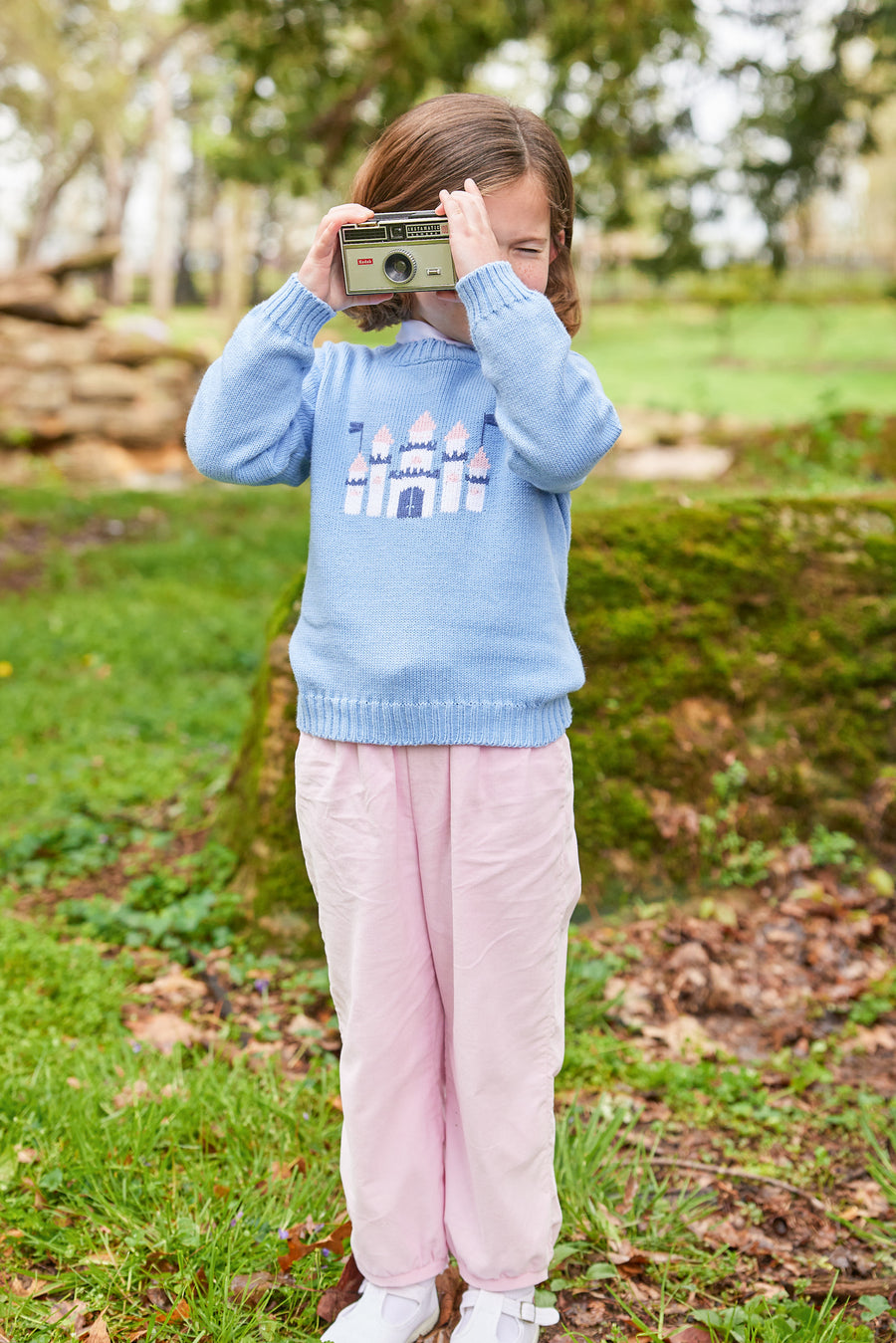 Little English traditional children's clothing. Light blue intarsia sweater with castle motif for little girl for Fall.