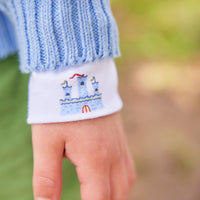 Little English traditional children's clothing. Light blue intarsia sweater with fort motif for little boy for Fall.