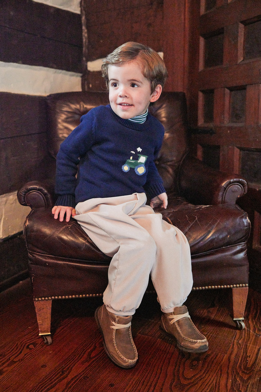 Little English traditional children's clothing. Navy blue intarsia sweater with tractor  motif for little boy for Fall.