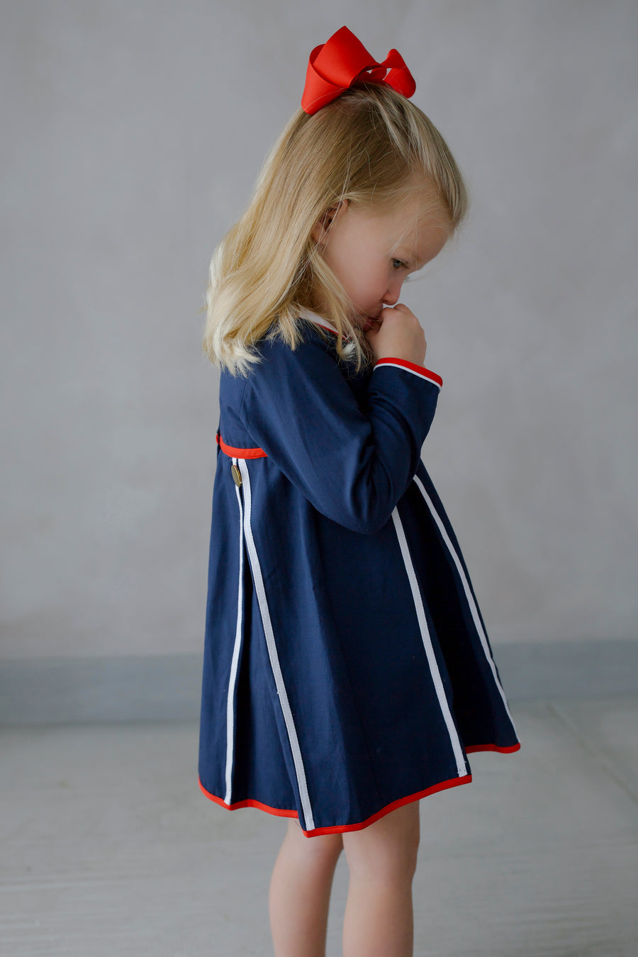 Little English traditional children's clothing. Navy long-sleeve peter pan dress with red and white trim for little girls for Fall