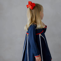 Little English traditional children's clothing. Navy long-sleeve peter pan dress with red and white trim for little girls for Fall