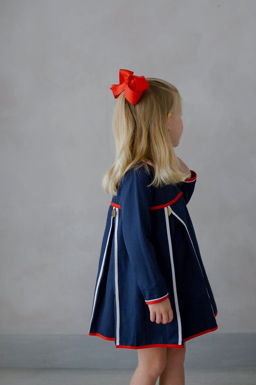 Little English traditional children's clothing. Navy long-sleeve peter pan dress with red and white trim for little girls for Fall