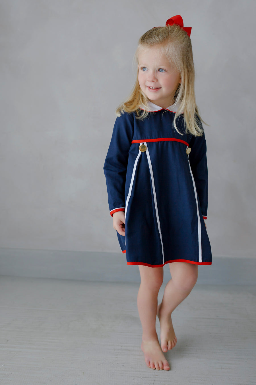 Little English traditional children's clothing. Navy long-sleeve peter pan dress with red and white trim for little girls for Fall