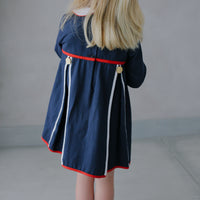 Little English traditional children's clothing. Navy long-sleeve peter pan dress with red and white trim for little girls for Fall