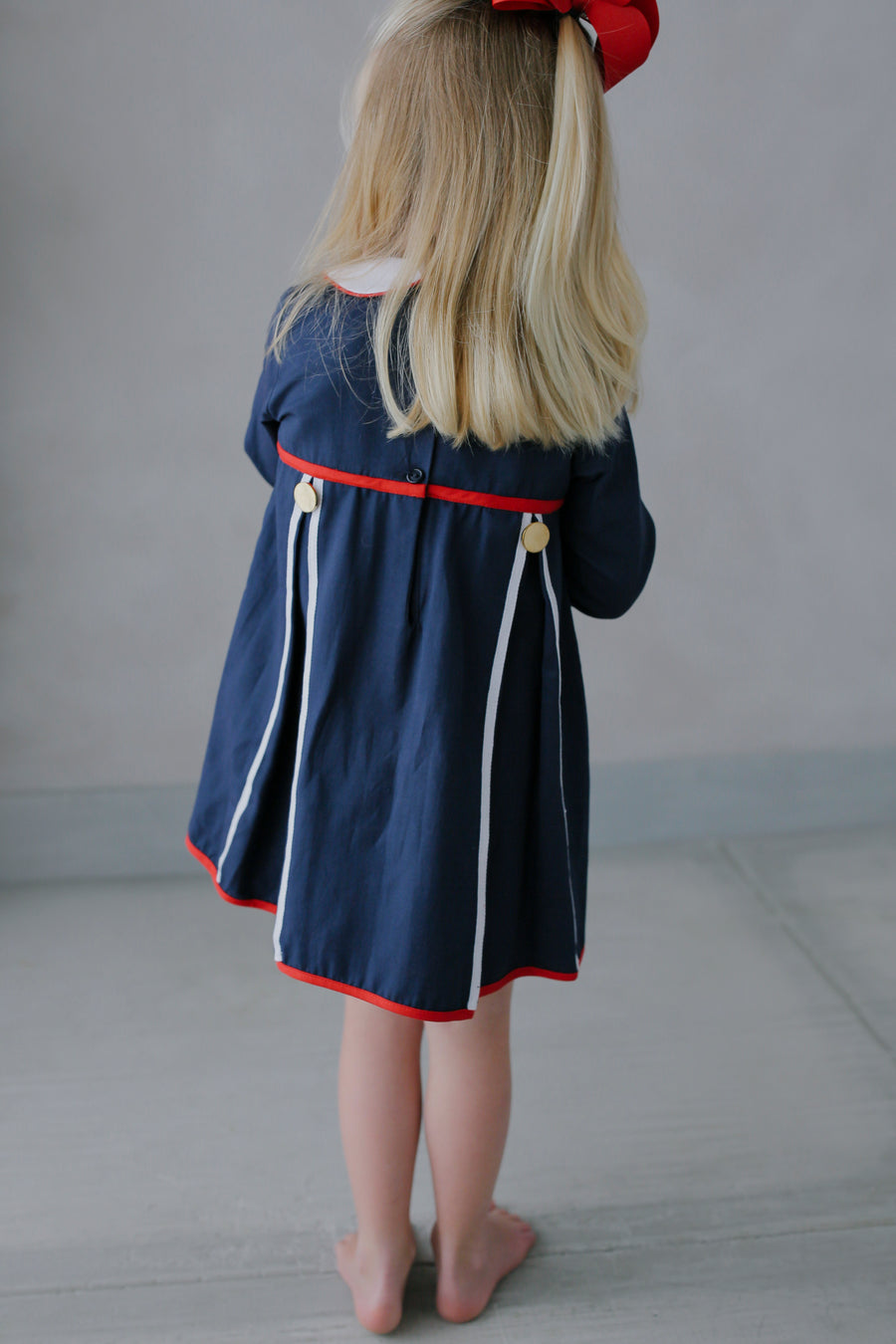 Little English traditional children's clothing. Navy long-sleeve peter pan dress with red and white trim for little girls for Fall