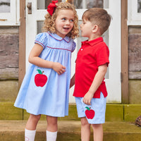 Little English traditional children's clothing. Light blue chambray basic short for little boy . Back to school shorts with red apple applique for fall. Paired with our red short sleeve polo.