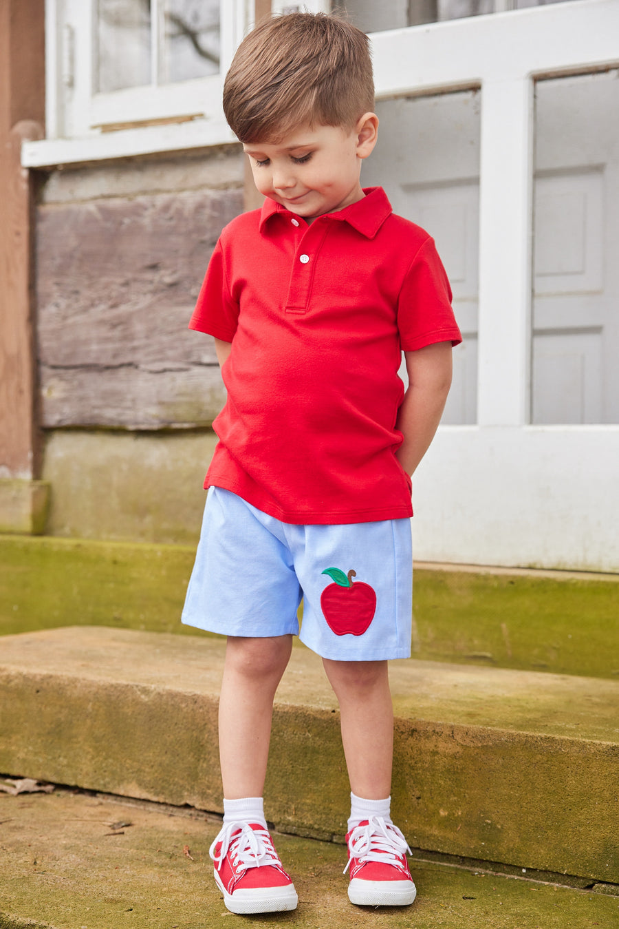 Little English traditional children's clothing. Light blue chambray basic short for little boy . Back to school shorts with red apple applique for fall. Paired with our red short sleeve polo.