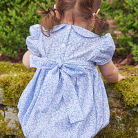 Little English traditional children's clothing. Classic smockked blue floral peter pan bubble with navy bows for little girl for Fall