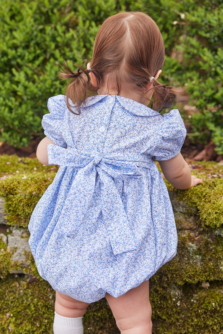 Little English traditional children's clothing. Classic smockked blue floral peter pan bubble with navy bows for little girl for Fall