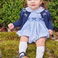 Little English traditional children's clothing. Classic smockked blue floral peter pan bubble with navy bows for little girl for Fall