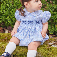 Little English traditional children's clothing. Classic smockked blue floral peter pan bubble with navy bows for little girl for Fall