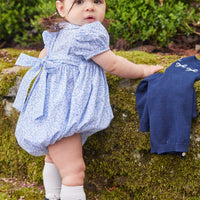 Little English traditional children's clothing. Classic smockked blue floral peter pan bubble with navy bows for little girl for Fall