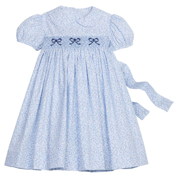 Little English traditional children's clothing. Classic smockked blue floral peter pan dress with navy bows for little girl for Fall