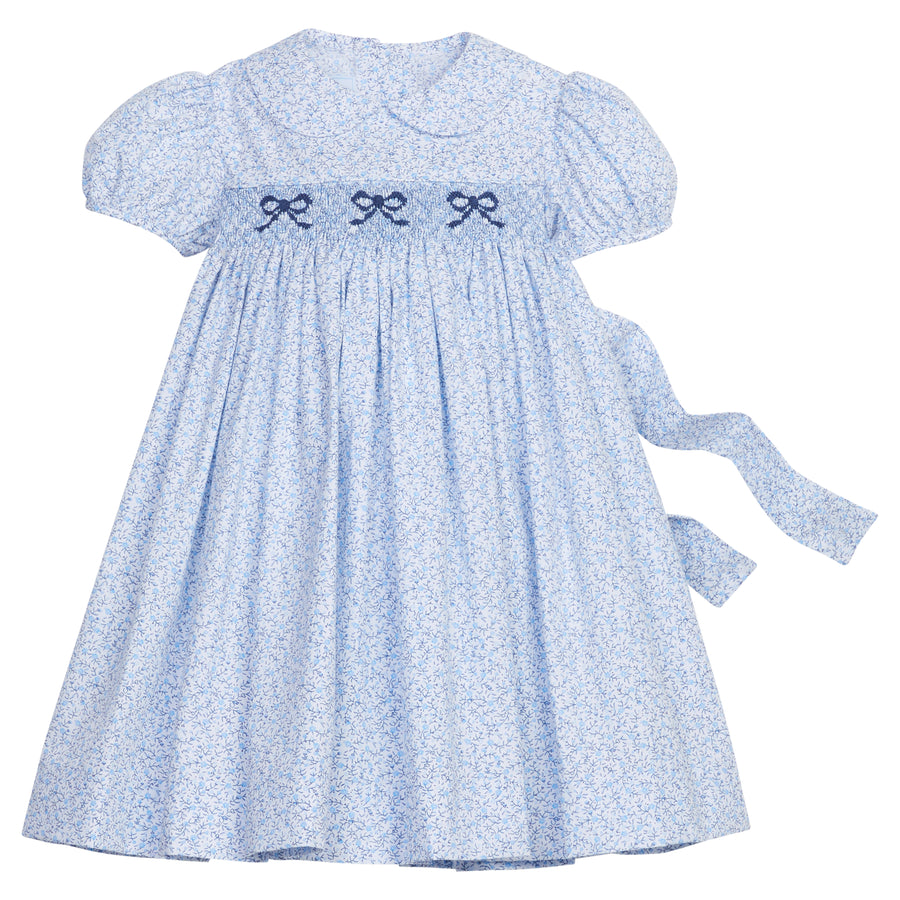 Little English traditional children's clothing. Classic smockked blue floral peter pan dress with navy bows for little girl for Fall