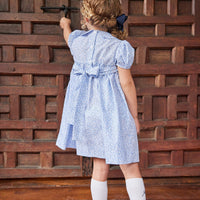 Little English traditional children's clothing. Classic smockked blue floral peter pan dress with navy bows for little girl for Fall