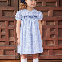 Little English traditional children's clothing. Classic smockked blue floral peter pan dress with navy bows for little girl for Fall