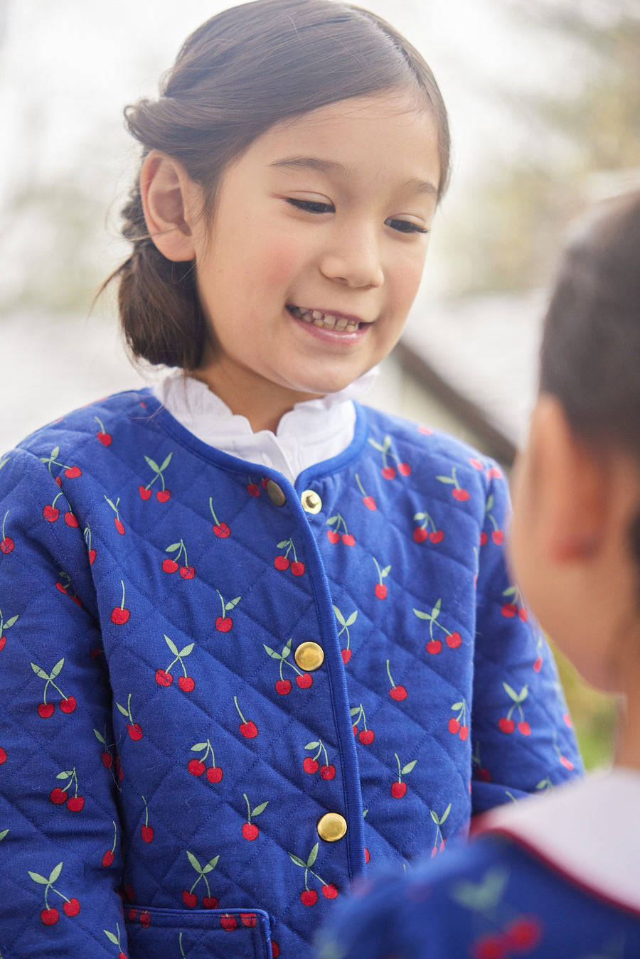 Little English traditional children's clothing.  Blue quilted jacket with cherry print for girls for Fall